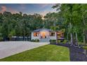 Beautiful home with a well-manicured lawn, featuring a covered porch and mature trees at 128 Paul Dr, Summerville, SC 29483