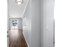 Hallway view showcasing wood floors, leading to a bright living area with a sliding door to the outside at 130 River Landing Dr # 4102, Charleston, SC 29492