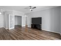 Spacious living room featuring hardwood floors, a modern TV, and decorative double doors at 130 River Landing Dr # 4102, Charleston, SC 29492