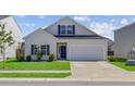 Charming two-story home with a well-maintained lawn, a garage, and a classic architectural style at 134 Percheron Dr, Summerville, SC 29486