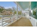 Spacious porch view showcases white railings, wooden flooring, and outdoor ambiance at 1340 Lucinda St, Mount Pleasant, SC 29466