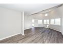 This open living room features luxury vinyl floors, abundant natural light and neutral paint at 142 Marsh View Villas, Folly Beach, SC 29439