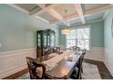 Formal dining room with coffered ceilings, a large window, and elegant table setting at 149 Daniels Ridge Dr, Summerville, SC 29485