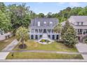 Beautifully landscaped home with palm trees and an expansive lawn at 1711 Indigo Island Dr, Hanahan, SC 29410