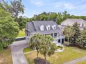 Aerial view of a gorgeous home surrounded by lush greenery, mature trees, and impeccable landscaping at 1711 Indigo Island Dr, Hanahan, SC 29410