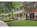 Inviting two-story home with double porches, brick walkway, and manicured landscaping at 1787 Tennyson Row # 9, Mount Pleasant, SC 29466
