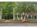 Beautiful two-story home with double porches, inviting entrance, and lush green trees at 1787 Tennyson Row # 9, Mount Pleasant, SC 29466