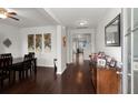 Inviting hallway with dark wood floors, elegant decor, and a view leading to the staircase at 203 Yeamans Way, Summerville, SC 29483