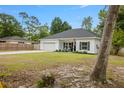 Attractive single-story home with a well-kept front yard, a long driveway, and inviting entryway with black shutters at 204 Read St, Moncks Corner, SC 29461