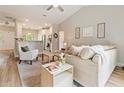 Open concept living room with light-colored walls, wood floors, modern furniture, and views of the kitchen at 204 Read St, Moncks Corner, SC 29461