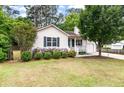 Charming single-story home with light siding, blue door, manicured landscaping, and attached garage at 209 Lipman St, Summerville, SC 29483