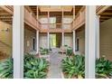 Charming courtyard with stone pavers, wooden benches, and verdant tropical plants at 2121 Egret Crest Ln, Charleston, SC 29414