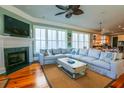 Inviting living room with a cozy fireplace and ample natural light at 25 Ocean Point Dr, Isle of Palms, SC 29451