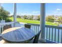 Covered porch with dining table overlooking a scenic view at 25 Ocean Point Dr, Isle of Palms, SC 29451