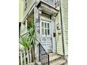 Entryway with decorative columns and a weathered, character-rich front door at 3 Hanover St, Charleston, SC 29403