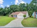 Well-maintained single-story home with a large yard, two car garage, and mature trees at 300 Hamlet Rd, Summerville, SC 29485