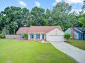 Inviting one-story home featuring a well-kept lawn, a two-car garage, and pleasing curb appeal at 300 Hamlet Rd, Summerville, SC 29485