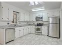 Bright kitchen featuring granite countertops, stainless steel appliances, and white cabinets at 302 Springview Ln # 10, Summerville, SC 29485
