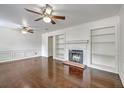 Spacious living room featuring a fireplace, built-in shelves, and hardwood floors at 302 Springview Ln # 10, Summerville, SC 29485