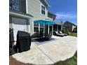 Spacious concrete patio with a grill, outdoor dining furniture, and lounge chairs overlooking the yard at 315 Grouse Park, Charleston, SC 29414