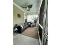 Cozy screened porch with comfortable seating, a ceiling fan, and decorative elements at 315 Grouse Park, Charleston, SC 29414