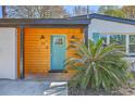 Close-up of the bright-colored front door with a well-kept landscape at 32 Briarcliff Dr, Charleston, SC 29407