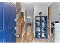 Welcoming foyer with wood-look flooring and a view of the staircase, featuring a charming shoe rack at 332 Damascus Dr, Summerville, SC 29483
