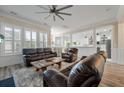 Open living room with hardwood floors and leather furniture, bathed in natural light at 3656 Spindrift Dr, Mount Pleasant, SC 29466