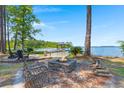 Lakeside with fire pit, swing, and dock providing a great outdoor space at 423 Lake Moultrie Dr, Bonneau, SC 29431