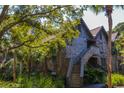 Two-story home exterior featuring wood shingles, stairs, and surrounded by lush greenery at 4233 Mariners Watch, Johns Island, SC 29455