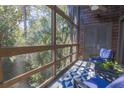 Relaxing screened porch with comfortable blue chairs and wooded views at 4233 Mariners Watch, Johns Island, SC 29455