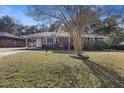 Charming brick home with an attached carport nestled on a picturesque lot at 4765 S Constellation Dr, North Charleston, SC 29418