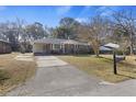 Charming brick home with an attached carport, classic mailbox, and lovely landscaping at 4765 S Constellation Dr, North Charleston, SC 29418