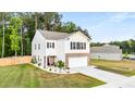 Well-maintained home featuring a two-car garage, beautiful lawn, and classic architectural details at 514 Shady Maple St, Moncks Corner, SC 29461