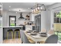 Stylish eat-in kitchen with stainless steel appliances, pendant lighting, and gray and white cabinetry at 5155 Monterey St, North Charleston, SC 29405