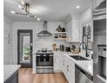 Bright kitchen featuring stainless steel appliances, white subway tiles, and quartz countertops at 5155 Monterey St, North Charleston, SC 29405