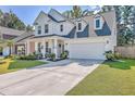 Charming two-story white home with a well-maintained lawn and spacious driveway at 612 S Pointe Blvd, Summerville, SC 29483