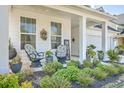 Inviting front porch with comfortable seating and beautifully landscaped garden at 612 S Pointe Blvd, Summerville, SC 29483
