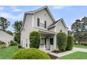Inviting two-story home with a cozy front porch and manicured landscaping, enhancing curb appeal at 613 Antebellum Ln, Mount Pleasant, SC 29464