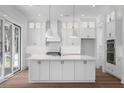 Beautiful all-white kitchen with a large center island and modern appliances at 6518 Beagle Club Rd, Meggett, SC 29449