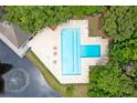Aerial view of a community pool and amenities including lounge chairs and tables at 7955 Timbercreek Ln # 1807, North Charleston, SC 29418