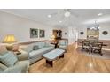 Bright living room featuring hardwood floors, elegant furniture, and a seamless flow to the dining area at 8 Town Park Ln # C, Charleston, SC 29412