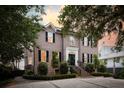 A stately two-story brick home with manicured landscaping and a brick driveway at 80 On The Harbor Dr, Mount Pleasant, SC 29464