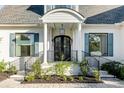 Inviting home entrance showcasing a columned porch and meticulously landscaped front yard at 853 Whispering Marsh Dr, Charleston, SC 29412