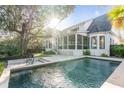 Stunning backyard oasis featuring a private pool, screened porch, and lush landscaping at 853 Whispering Marsh Dr, Charleston, SC 29412