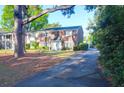 Brick townhome with mature trees and front door, complemented by a paved driveway at 926 Lansing Dr # 926-G, Mount Pleasant, SC 29464