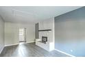 Spacious living room with a cozy fireplace and sleek gray flooring at 960 Savage Road Rd, Charleston, SC 29414