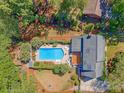 Aerial view showcasing a private backyard with a sparkling swimming pool, lounge chairs, and a wooden deck at 968 Cummings Cir, Mount Pleasant, SC 29464