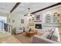 Cozy living room with a fireplace, built-in bookshelves, and beamed ceiling at 106 Newington Rd, Summerville, SC 29485