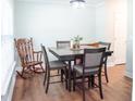 Well-lit dining area with hardwood floors featuring a wooden rocking chair and stylish table set at 109 Holly St, Summerville, SC 29485